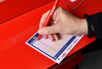 Close-up of a player filling out a EuroMillions ticket.